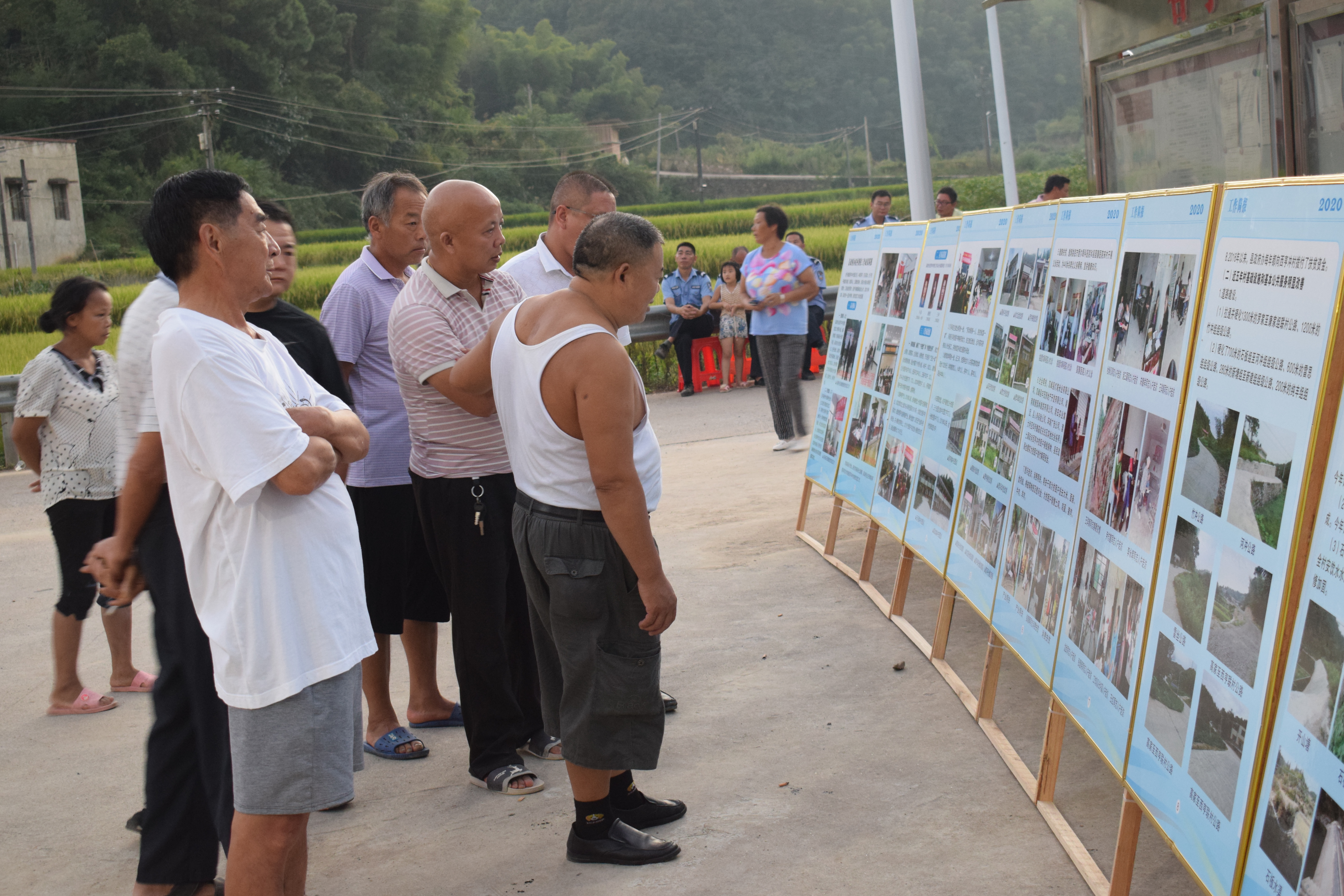 村民在观看脱贫攻坚成果展板２.JPG